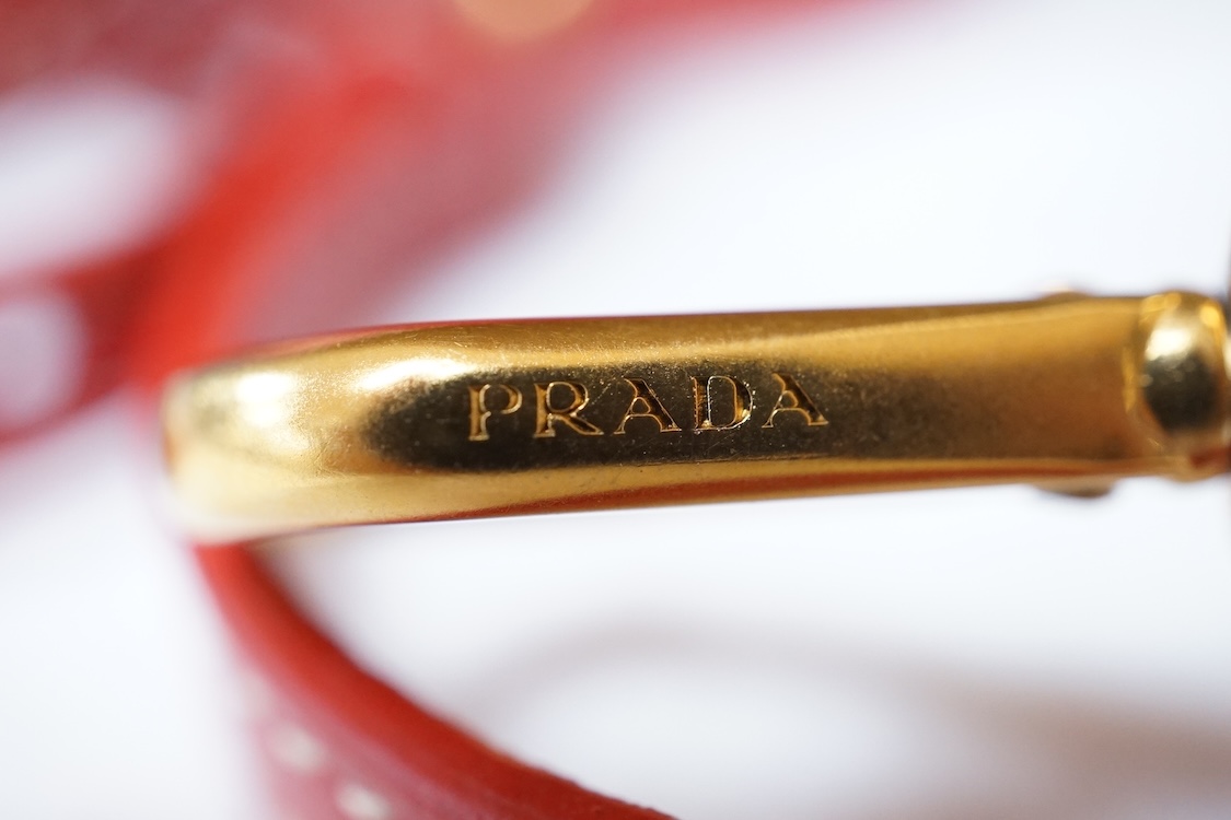 A Prada red braided leather handbag with shoulder strap, authenticity card and dust cover, 25cm wide, Provenance: Purchased by the vendor in Selfridges
